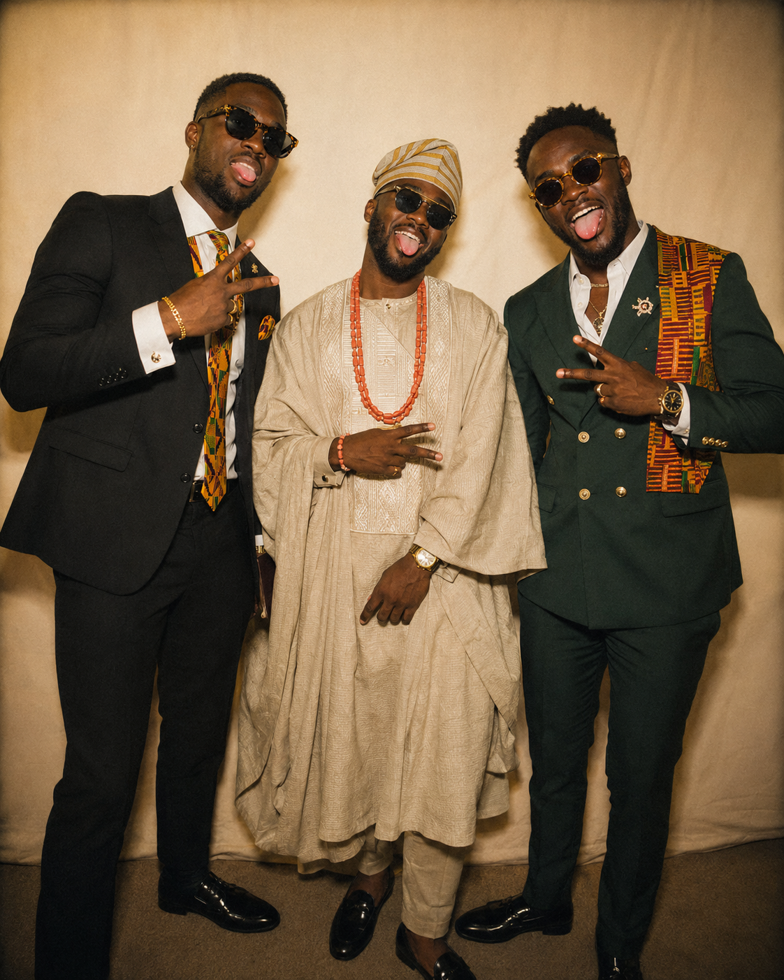 Three guests in formal attire, one in a beige agbada with coral beads